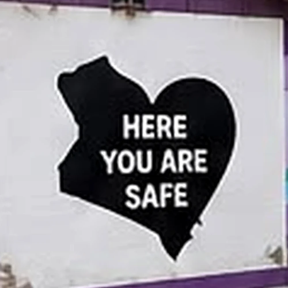 The words Here You Are Safe painted on Kenneth & Jacob's House